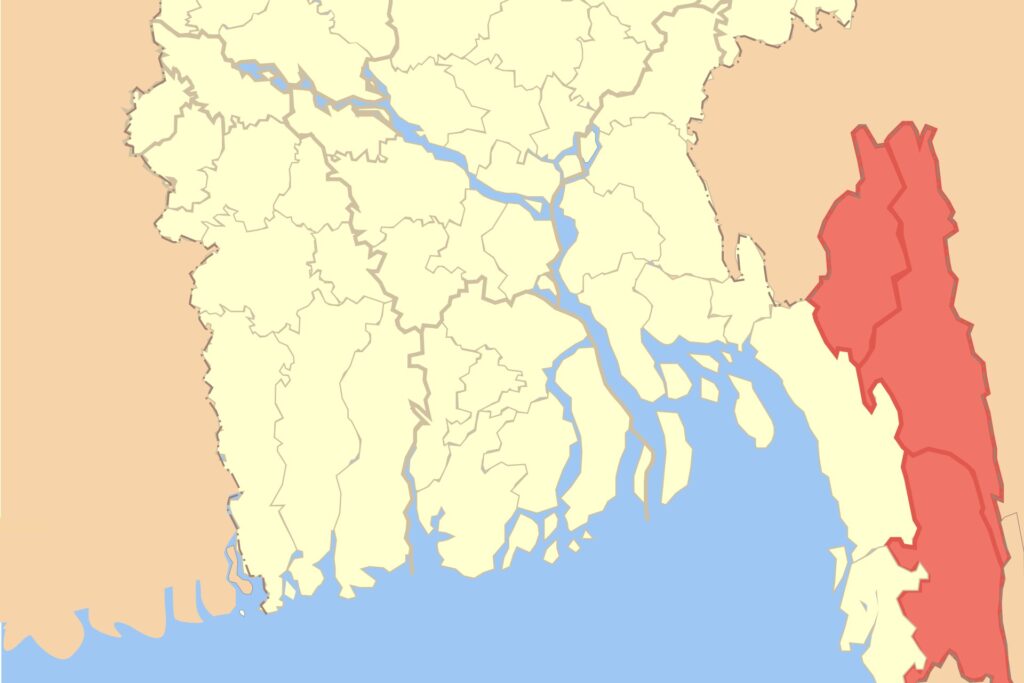 Map of southern Bangladesh with the three hill districts of the Chittagong Hill Tracts shaded red along the south-eastern border, the Bay of Bengal in blue below